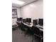 Community computer room with multiple stations and chairs at 11715 Boynton Ln # 74B, New Port Richey, FL 34654