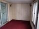 Enclosed Florida room with sliding windows and red carpet at 11715 Boynton Ln # 74B, New Port Richey, FL 34654