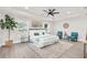 Serene main bedroom features a tray ceiling, neutral decor, and comfortable seating area at 12064 Cradock St, Spring Hill, FL 34608