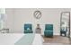 Close up of main bedroom seating area with two chairs, decor and natural light at 12064 Cradock St, Spring Hill, FL 34608