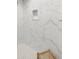 The walk-in shower features a built-in niche, white marble, and a wooden stool at 12064 Cradock St, Spring Hill, FL 34608