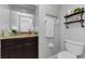 Bathroom featuring a vanity with granite countertops, a toilet, and decorative shelving at 1236 Ketzal Dr, Trinity, FL 34655
