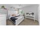 Comfortable bedroom with a white bed frame, ceiling fan and neutral carpet at 1236 Ketzal Dr, Trinity, FL 34655