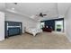 Spacious primary bedroom with tray ceiling, ceiling fan and desk with a view at 1236 Ketzal Dr, Trinity, FL 34655