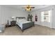 Neutrally decorated bedroom featuring a ceiling fan, neutral carpet and gray furniture at 1236 Ketzal Dr, Trinity, FL 34655