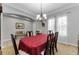 Formal dining room featuring a decorative chandelier and seating for six at 1236 Ketzal Dr, Trinity, FL 34655