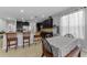 Bright kitchen with granite countertops, dark cabinets, and open dining area at 1236 Ketzal Dr, Trinity, FL 34655