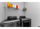 Modern laundry room features an LG washer and dryer set with storage shelves above at 1236 Ketzal Dr, Trinity, FL 34655