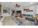 Spacious living room featuring a large sectional sofa, tile flooring, and an open layout leading to the kitchen at 1236 Ketzal Dr, Trinity, FL 34655