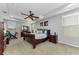 A serene primary bedroom with a ceiling fan, tray ceiling, and ample natural light from the windows with blinds at 1236 Ketzal Dr, Trinity, FL 34655