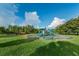 Community playground with colorful equipment and shade trees at 1236 Ketzal Dr, Trinity, FL 34655