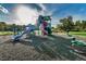 Community playground featuring multiple slides, climbing structures, and safety surfacing at 1236 Ketzal Dr, Trinity, FL 34655