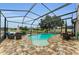 A luxurious in-ground pool with a screened enclosure and plenty of room for outdoor seating and entertaining at 1236 Ketzal Dr, Trinity, FL 34655