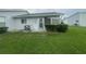 Well-maintained backyard with lush green grass, complemented by a view of the home's exterior at 12539 Dearborn Dr # A, Hudson, FL 34667