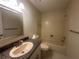 Clean bathroom with granite counters, framed mirror, and a shower-tub combo provides essential comfort at 12539 Dearborn Dr # A, Hudson, FL 34667