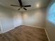 Cozy bedroom with wood floors and ceiling fan at 12539 Dearborn Dr # A, Hudson, FL 34667