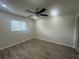 Comfortable bedroom with wood-look floors and a ceiling fan provides a tranquil space for rest and relaxation at 12539 Dearborn Dr # A, Hudson, FL 34667