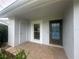 Covered entrance features a tiled foyer, storm door, and exterior storage at 12539 Dearborn Dr # A, Hudson, FL 34667