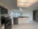 Open kitchen with a large countertop, white cabinets, and stainless steel appliances at 12539 Dearborn Dr # A, Hudson, FL 34667