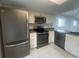 Modern kitchen with stainless steel appliances and white cabinetry at 12539 Dearborn Dr # A, Hudson, FL 34667