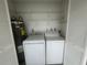 Functional laundry area features a washer, dryer, and water heater with ample shelving for storage at 12539 Dearborn Dr # A, Hudson, FL 34667