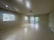 Bright living room with neutral colors, tile floors, and sliding glass door at 12539 Dearborn Dr # A, Hudson, FL 34667