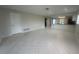 Bright open-plan living room with neutral colors and tile flooring at 12539 Dearborn Dr # A, Hudson, FL 34667