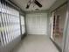 Bright sun room with tile flooring and a ceiling fan offers a versatile space for relaxation and enjoyment at 12539 Dearborn Dr # A, Hudson, FL 34667