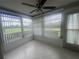 Enclosed patio featuring lots of natural light, tile flooring, and a ceiling fan, a perfect spot to relax at 12539 Dearborn Dr # A, Hudson, FL 34667