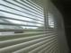 Scenic view through window blinds featuring lush greenery, perfect for relaxation and tranquility at 12539 Dearborn Dr # A, Hudson, FL 34667