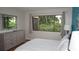 Well-lit bedroom with a large window, dresser, and peaceful ambiance at 13012 Wedgewood Way # A, Hudson, FL 34667