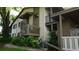 Charming building exterior featuring stairs, balcony and lush landscaping, enhancing its overall appeal at 13012 Wedgewood Way # A, Hudson, FL 34667