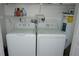 Efficient laundry area featuring a washer, dryer, and water heater for convenience at 13012 Wedgewood Way # A, Hudson, FL 34667