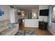 Open-concept living room boasts a modern TV, seamlessly connecting living spaces at 13012 Wedgewood Way # A, Hudson, FL 34667