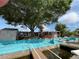 Inviting backyard featuring a large wooden deck, turquoise patio, and waterfront canal access at 13626 Allyn Dr, Hudson, FL 34667