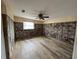 Bedroom with hardwood floors, ceiling fan, and natural light from the window at 13626 Allyn Dr, Hudson, FL 34667