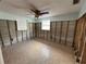 Bedroom with tile floors, ceiling fan, and a bright window at 13626 Allyn Dr, Hudson, FL 34667