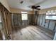 Spacious bedroom with wood-look tile floors and ceiling fan at 13626 Allyn Dr, Hudson, FL 34667