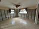 Bedroom with tile floors, ceiling fan, and natural light at 13626 Allyn Dr, Hudson, FL 34667