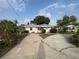 Charming single-story home with mature landscaping, concrete driveway, and covered front porch at 13626 Allyn Dr, Hudson, FL 34667