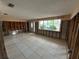 Spacious living room with tile floors, a large window, and exposed framing at 13626 Allyn Dr, Hudson, FL 34667