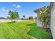 Expansive backyard featuring a manicured lawn, picnic table, and privacy fence at 13627 Lightning Rod Ct, Hudson, FL 34669