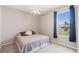 Bedroom with neutral colors, fan, and a window at 13627 Lightning Rod Ct, Hudson, FL 34669