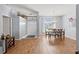 Open-concept dining area with hardwood floors, a stylish chandelier, and easy access to other living spaces at 13627 Lightning Rod Ct, Hudson, FL 34669
