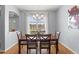 Elegant dining area with a chandelier, hardwood floors, and a large window providing ample natural light at 13627 Lightning Rod Ct, Hudson, FL 34669
