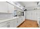 Spacious kitchen featuring white cabinets, modern countertops and stainless steel appliances at 13627 Lightning Rod Ct, Hudson, FL 34669