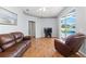Living room with hardwood floors and sliding doors to the pool area at 13627 Lightning Rod Ct, Hudson, FL 34669