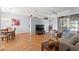 Bright and airy living room featuring hardwood floors and access to the dining and living spaces at 13627 Lightning Rod Ct, Hudson, FL 34669