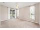 Spacious main bedroom with a ceiling fan, plush carpeting, and sliding glass doors leading to a screened-in porch at 13627 Lightning Rod Ct, Hudson, FL 34669