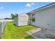 Backyard features storage shed, patio, and well-maintained lawn at 13627 Lightning Rod Ct, Hudson, FL 34669